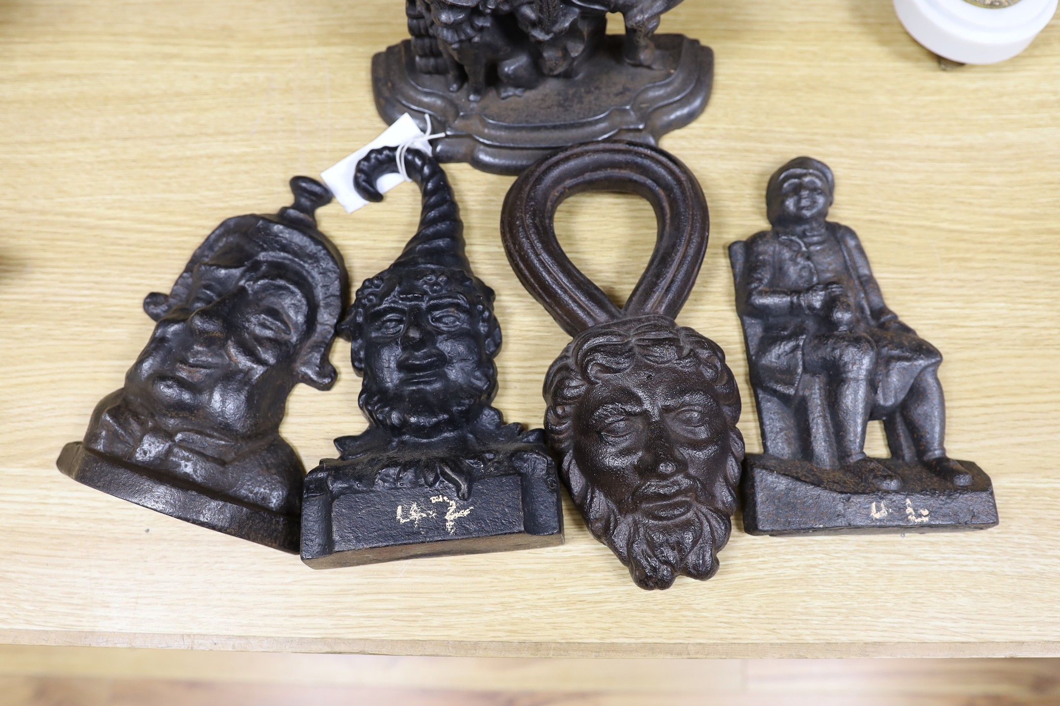 A Punch cast iron door stop and four other figural door stops, punch door stop 33cms high